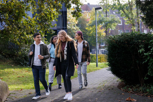 Students walk together across the campus of the Faculty of Textile and Clothing Technology