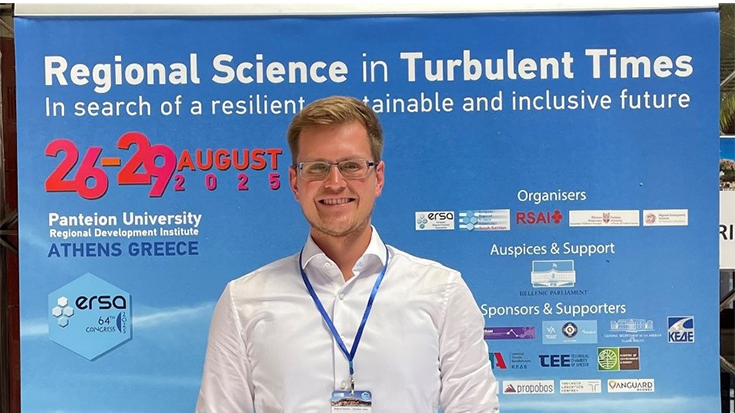 Florian Grebe in front of a poster at the European Regional Science Association.